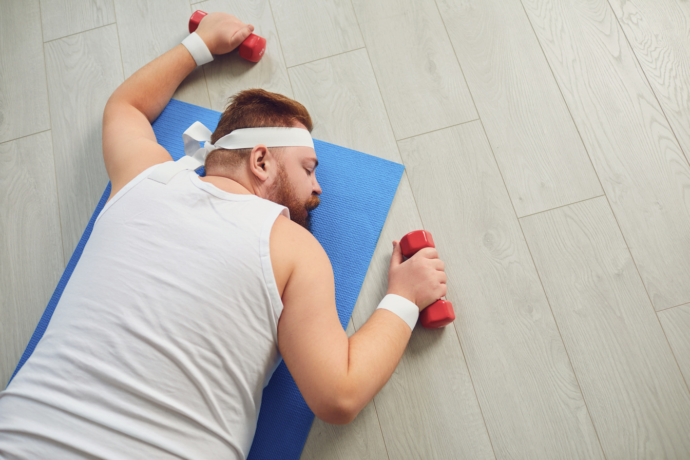 Curvy Man Sleeping While Exercising with Dumbbells